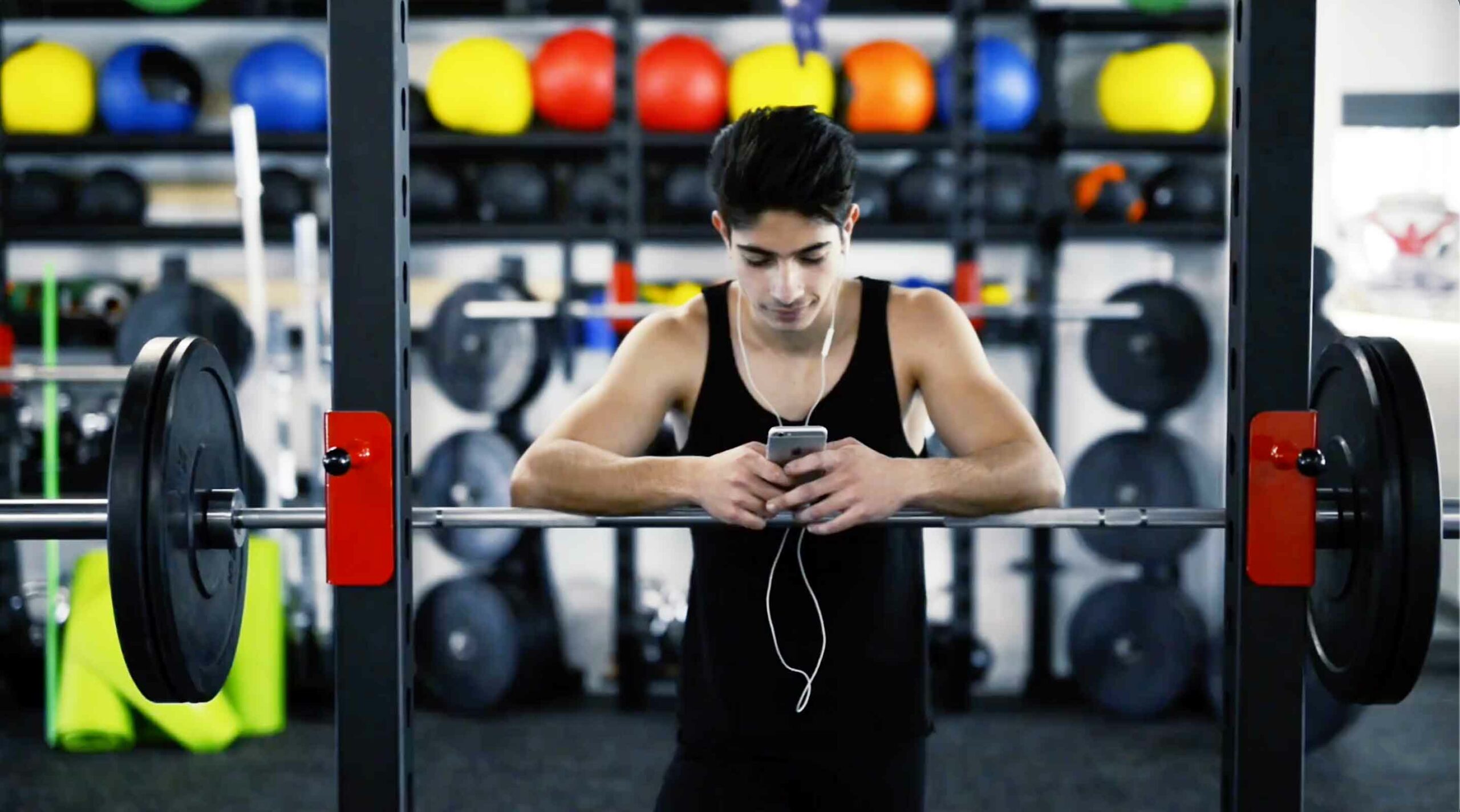 young male athlete on smartphone